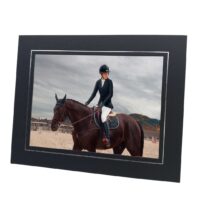 black and silver photo mount with photo of person riding horse