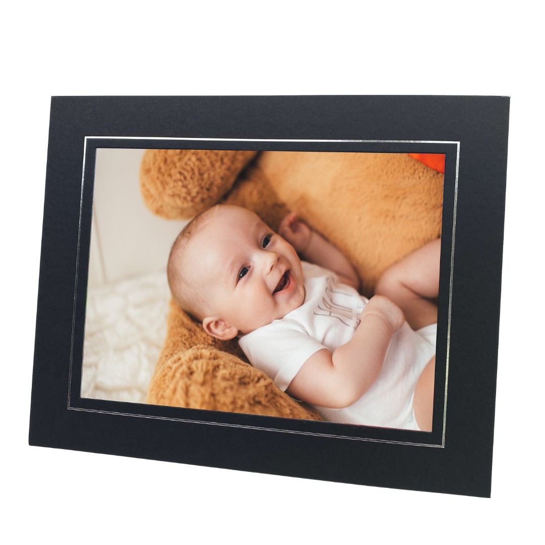 black and silver photo mount with photo of smiling baby