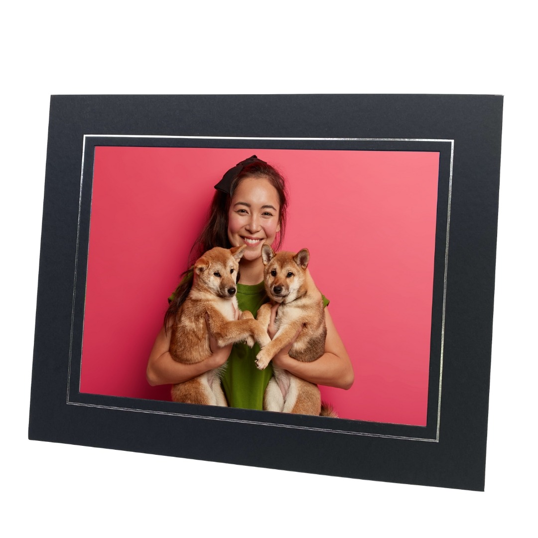 black and silver photo mount with photo of woman holding two dogs