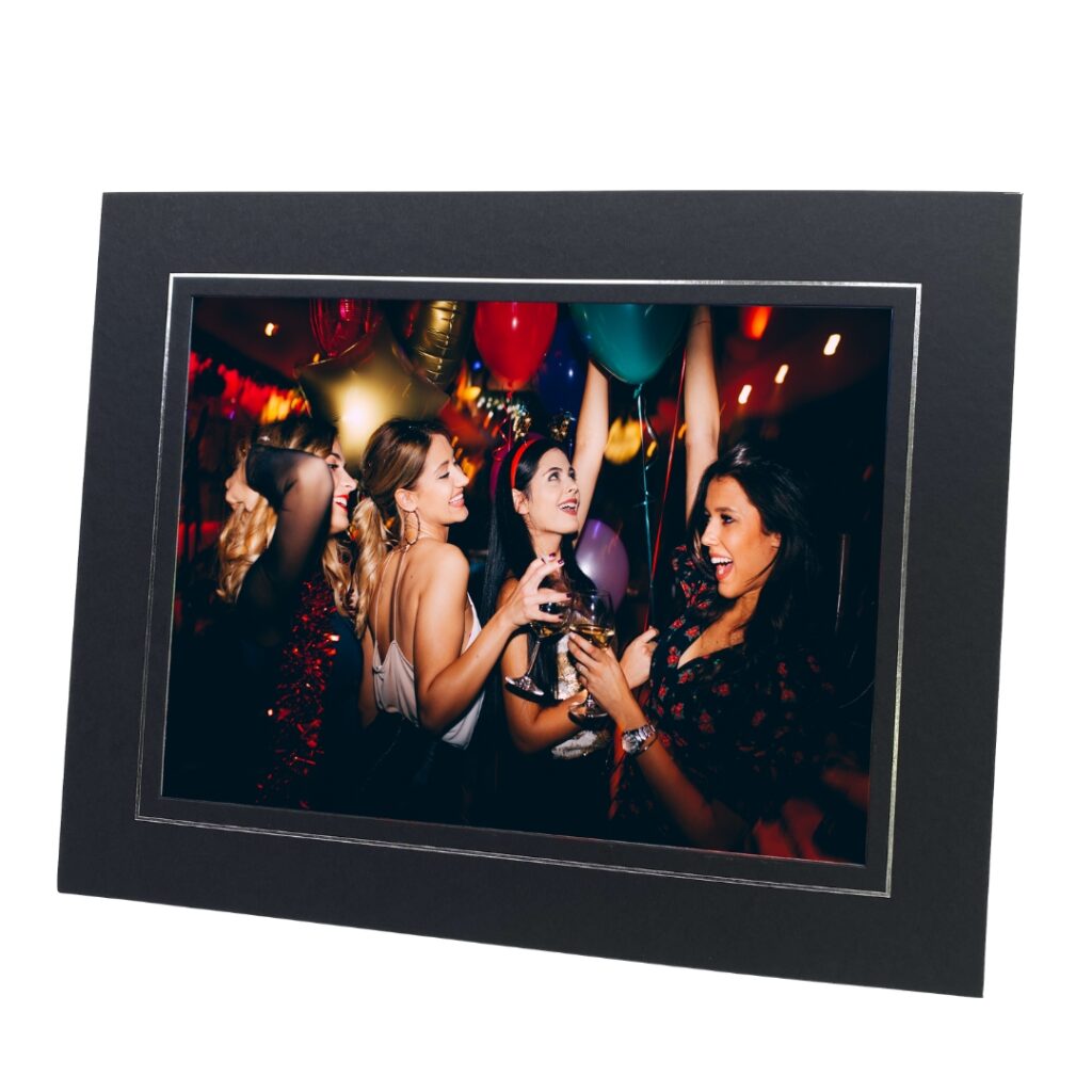 black and silver photo mount with photo of women dancing at a party