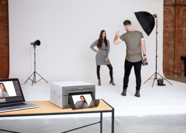 Photographer with a model, and a CX02W printer in the foreground.